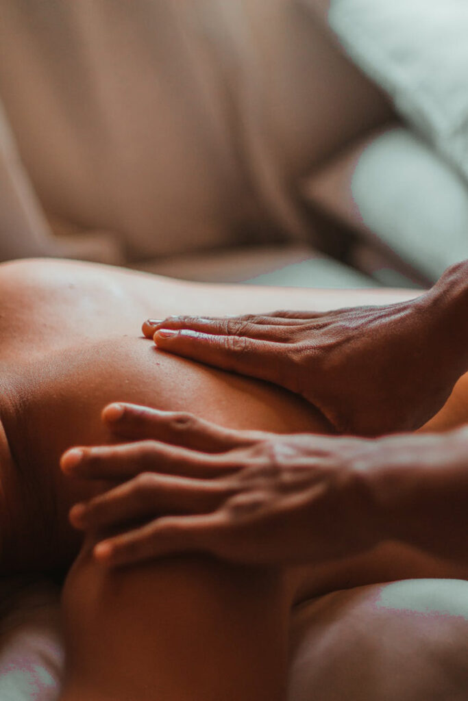 Hands Massaging The Upper Back